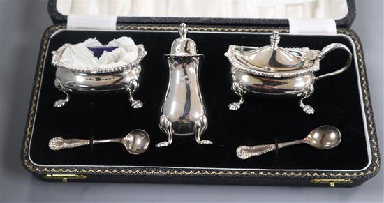 A five piece silver condiment set in Harrods box
